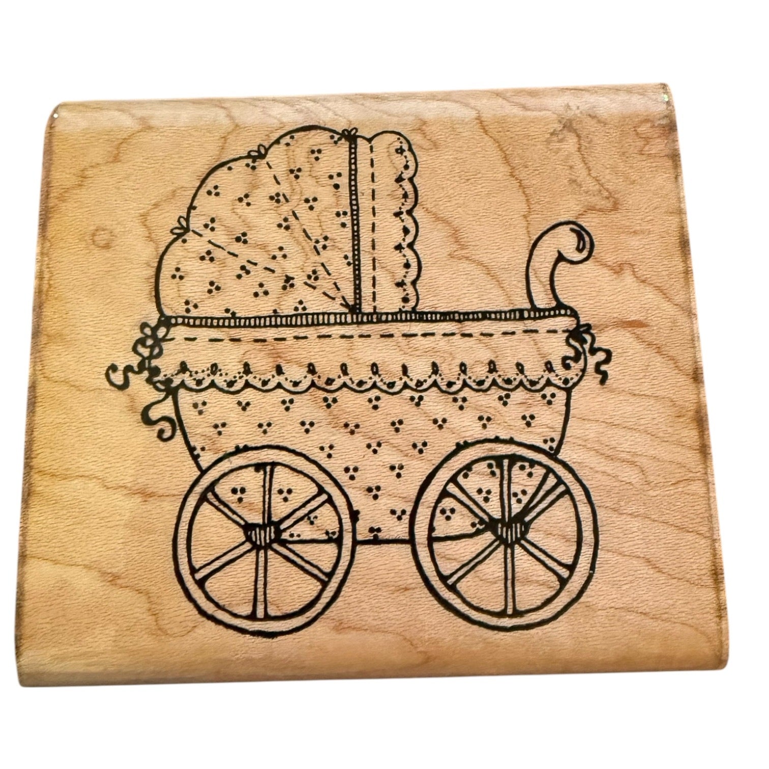 Wooden stamp with a image of a vintage baby carriage on a white background