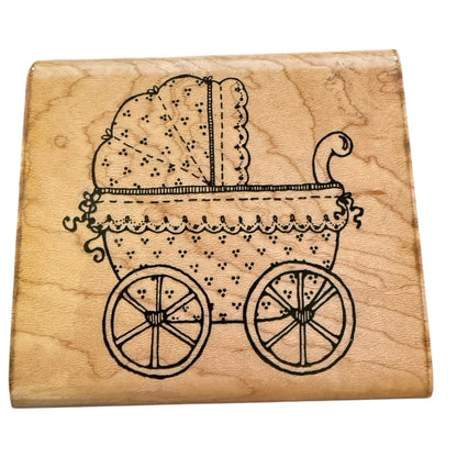Wooden stamp with a image of a vintage baby carriage on a white background