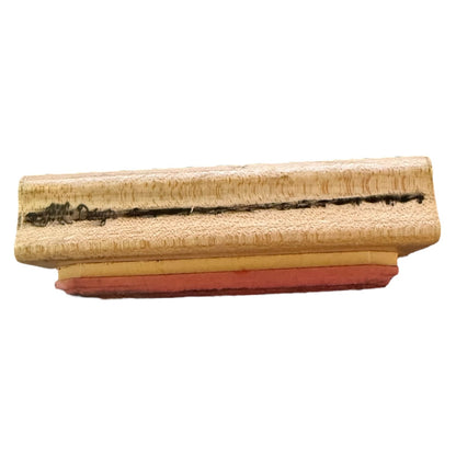 A rectangular wooden stamp block with a dark engraved design and a red rubber stamp face, shown against a plain white background.