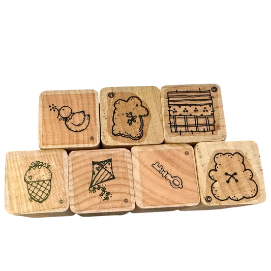 Set of wooden stamps with various designs on a white background