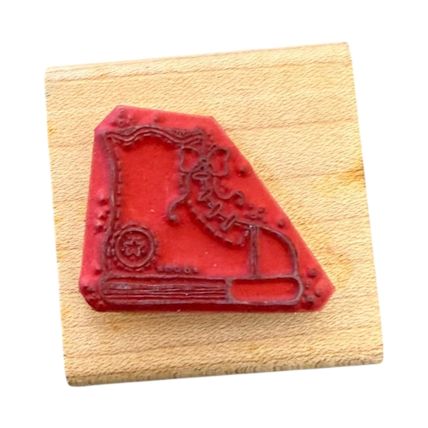 Red stamp with sneaker design on a wooden block