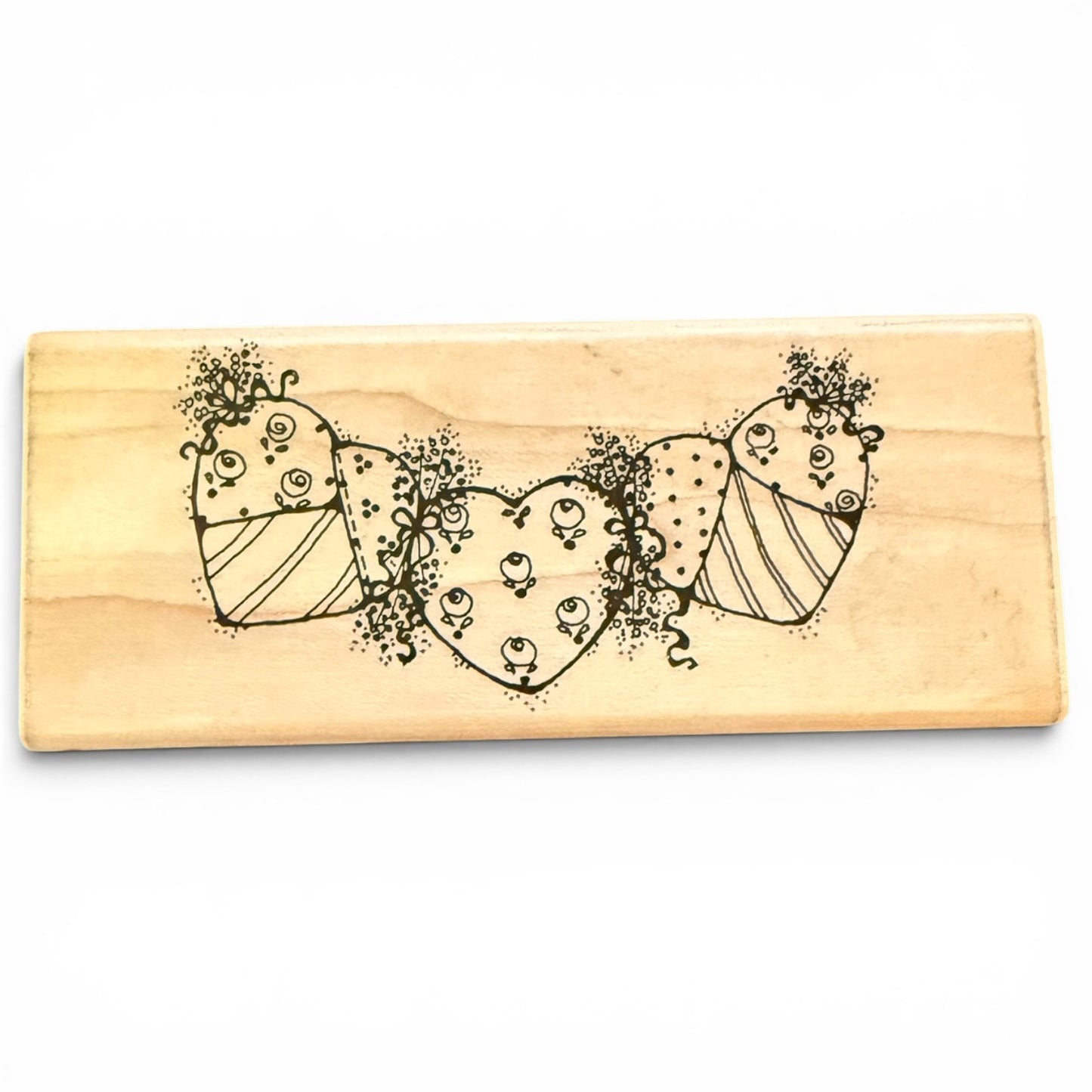 Wooden stamp with decorative heart design on a white background