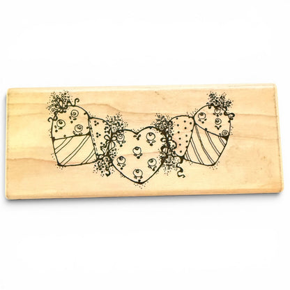 Wooden stamp with decorative heart design on a white background