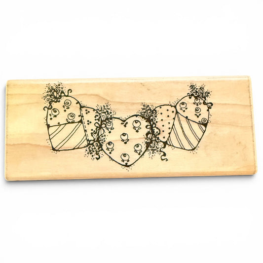 Wooden stamp with decorative heart design on a white background