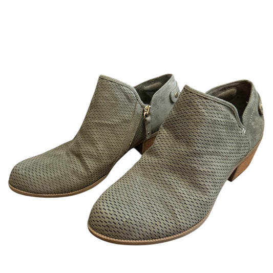 Pair of green ankle boots on a white background