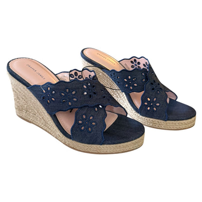 Front side of Navy wedge sandals with floral cutouts on a white background