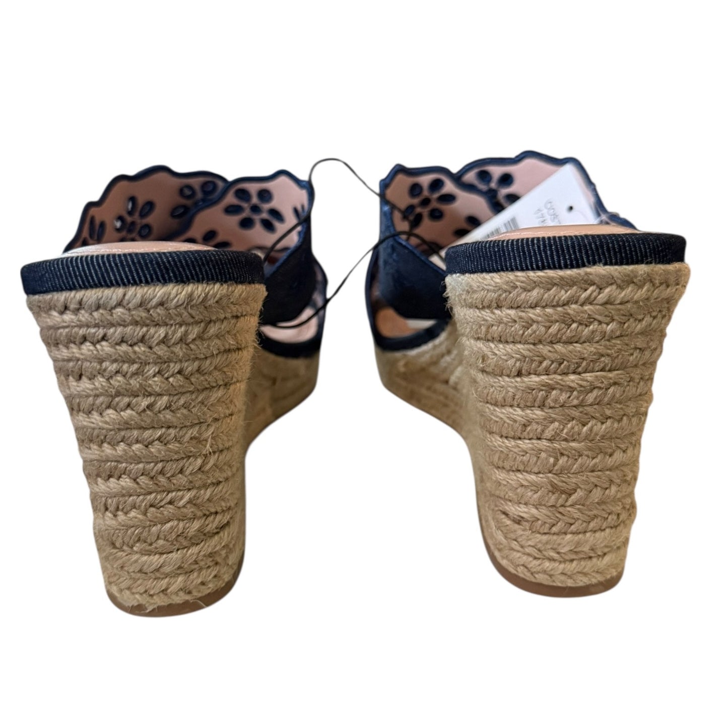 Back of Pair of wedge sandals and floral  design on a white background