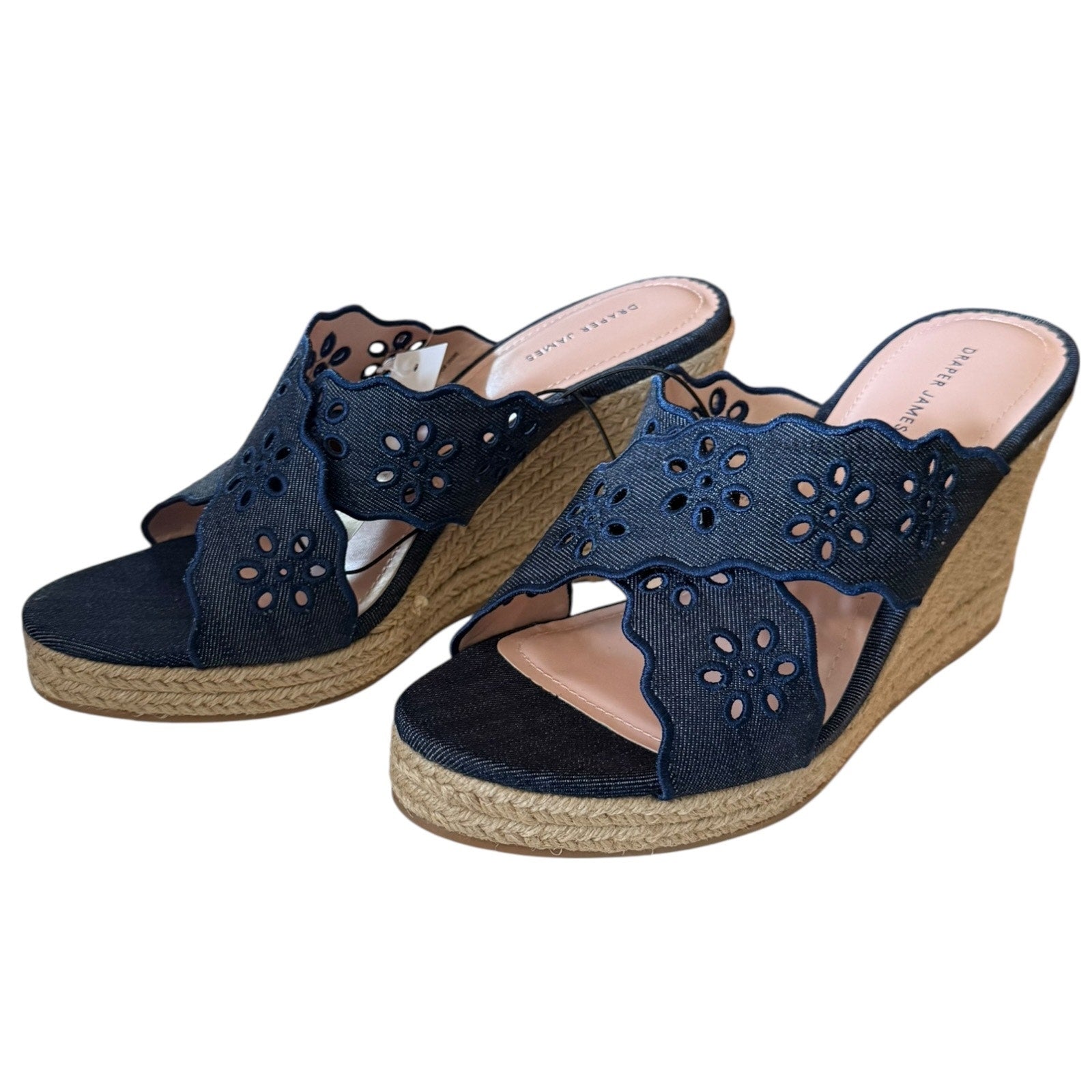 Front side of Pair of navy wedge sandals on a white background