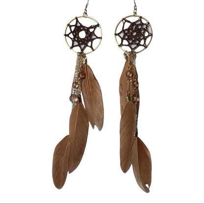 Pair of feather earrings with decorative elements on a white background