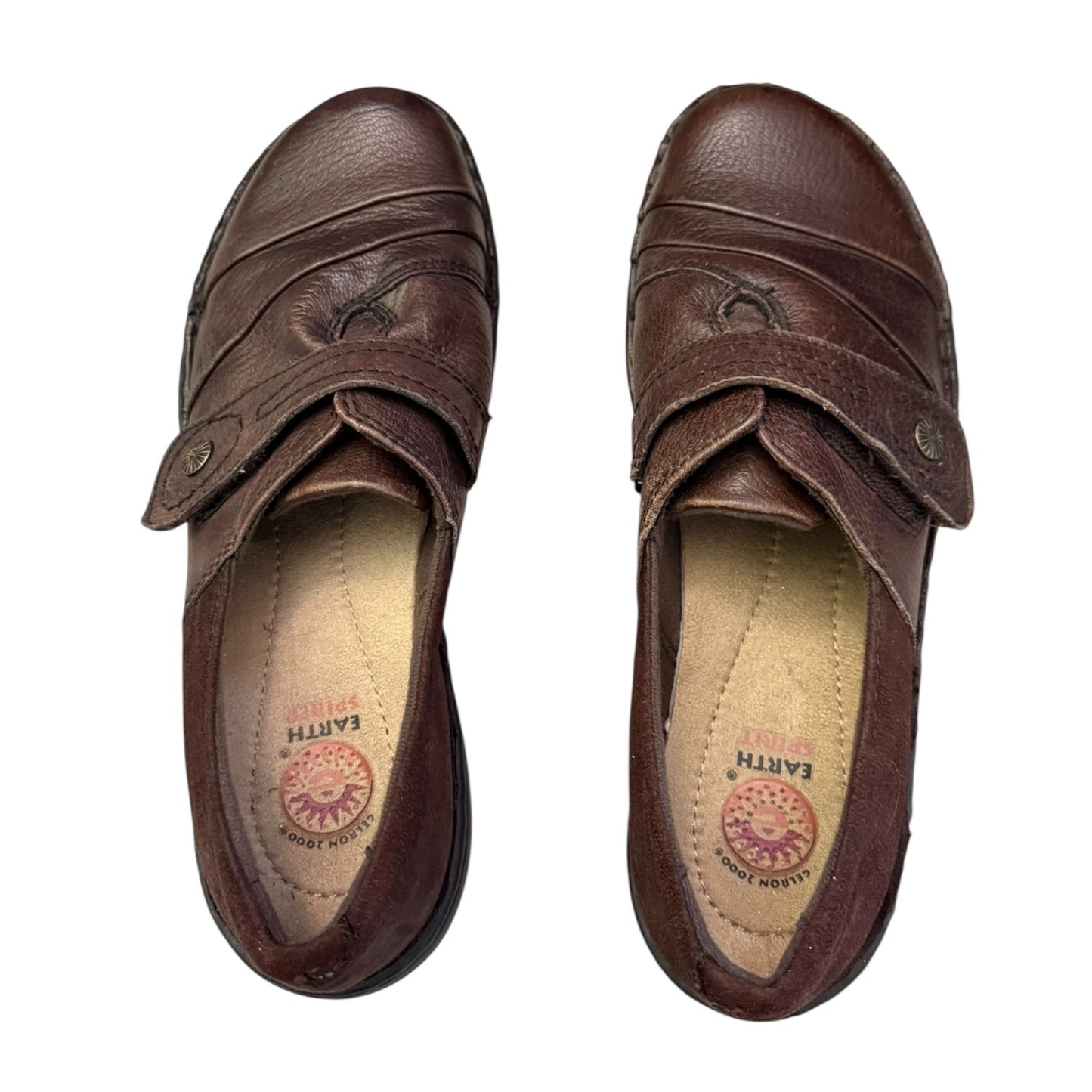 Top of brown shoes with visible brand logo on a white background