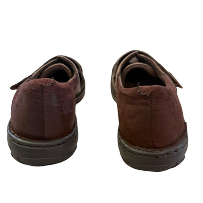 A pair of dark brown suede slip-on shoes shown from the back against a plain white background.
