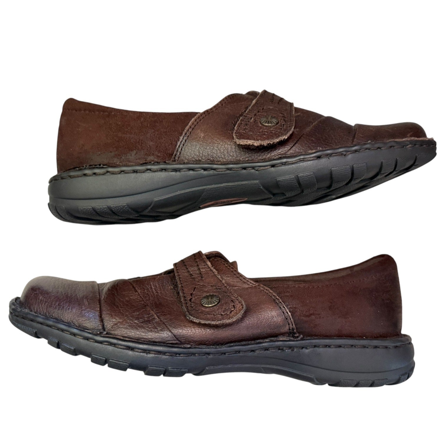 Side of brown leather shoes with black soles on a white background