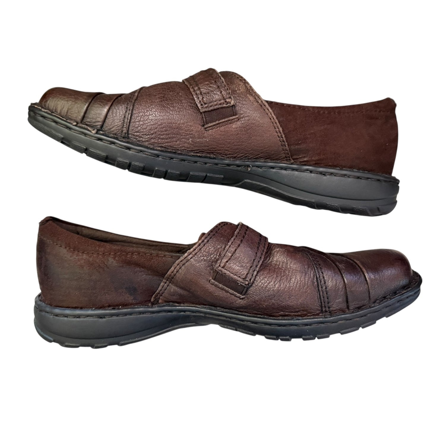 Side of brown leather shoes with velcro straps on a white background