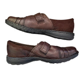 Side of brown leather shoes with velcro straps on a white background