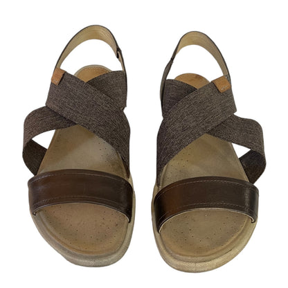 Pair of sandals with criss-cross straps on a white background