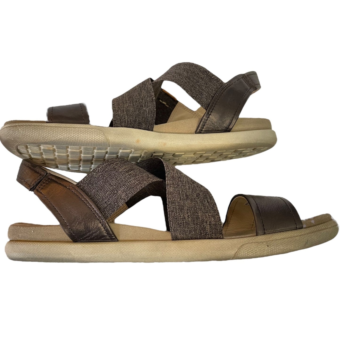 Side of sandals with criss-cross straps on a white background