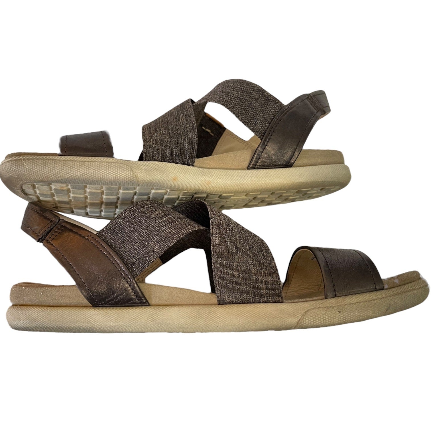 Side of sandals with criss-cross straps on a white background