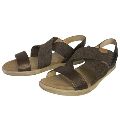 Front side of sandals with criss-cross straps on a white background