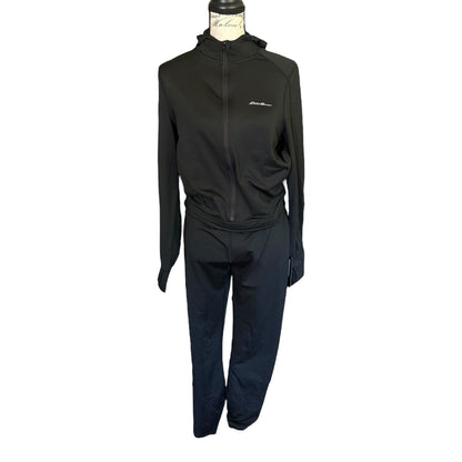 A black athletic black jumpsuit displayed on a mannequin torso against a plain white background.