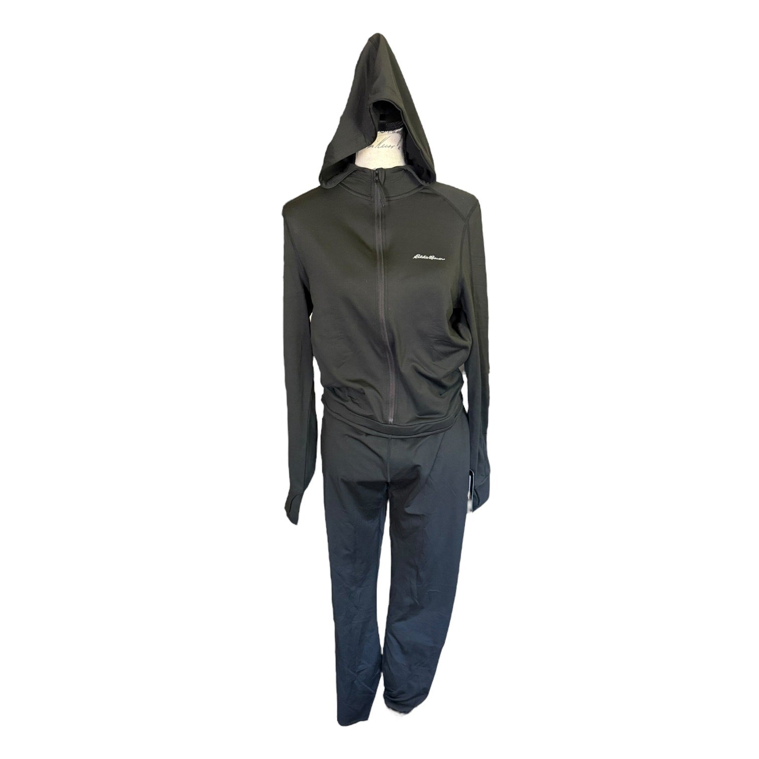 A black jumpsuit with hood displayed on a mannequin against a plain white background.