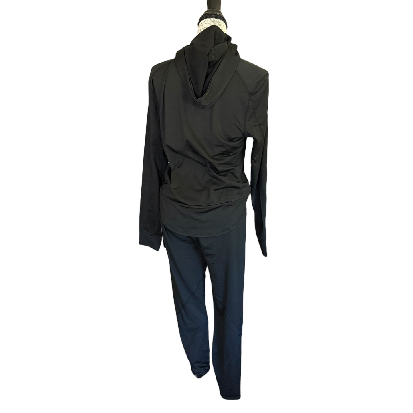 A black long-sleeve hooded jumpsuit displayed on a mannequin against a plain white background.