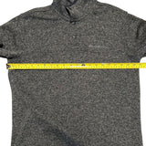 Gray sweater with a measuring tape across it on a white background