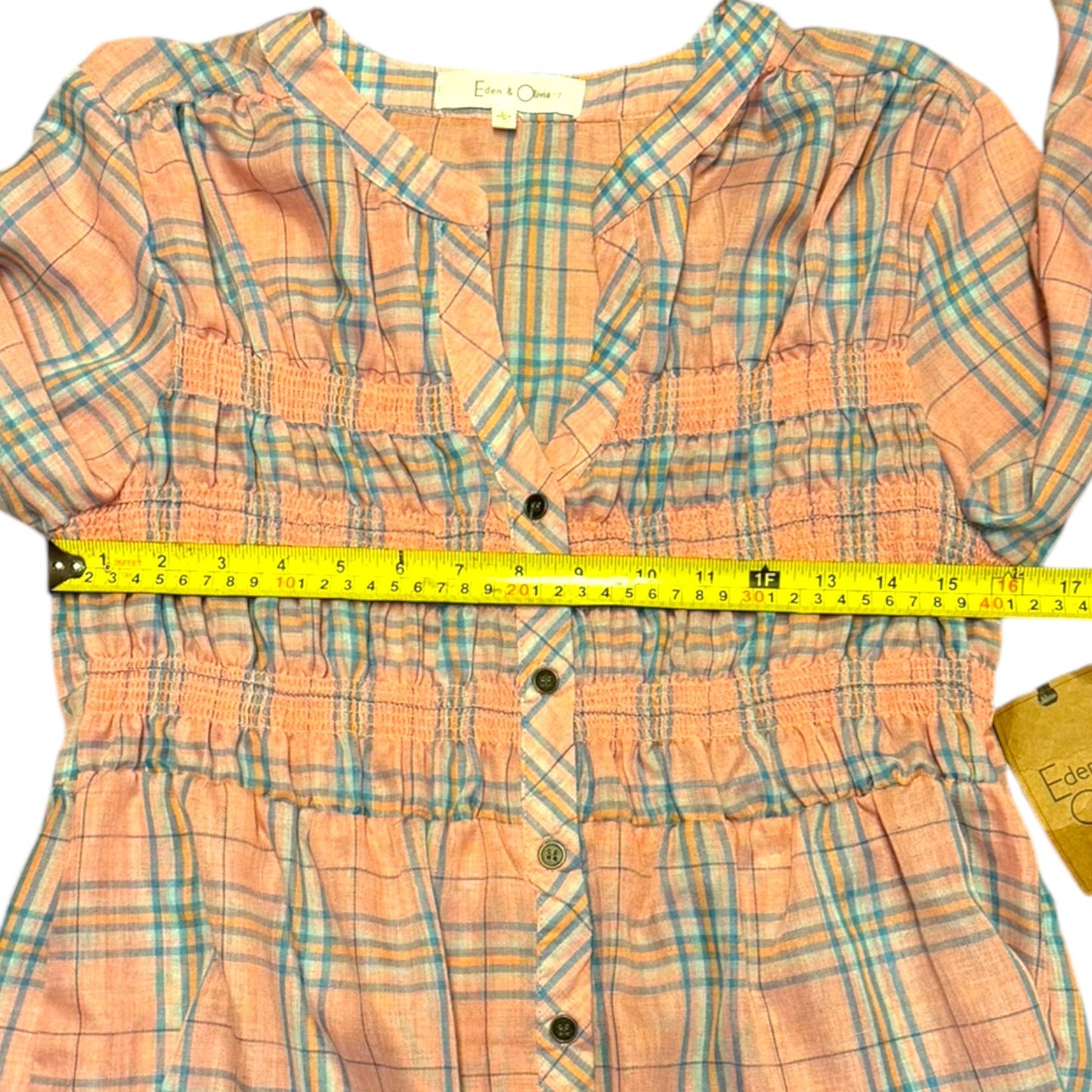Plaid shirt with a measuring tape on top, Edwards & Company label visible