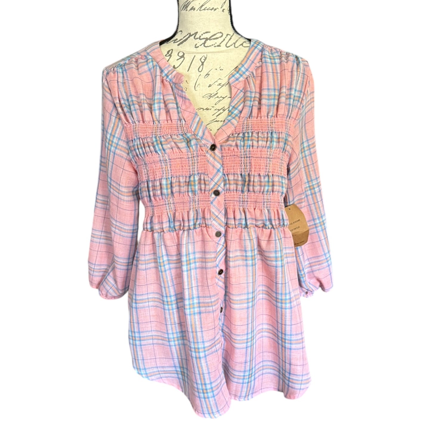 Plaid pink shirt on a mannequin with a white background