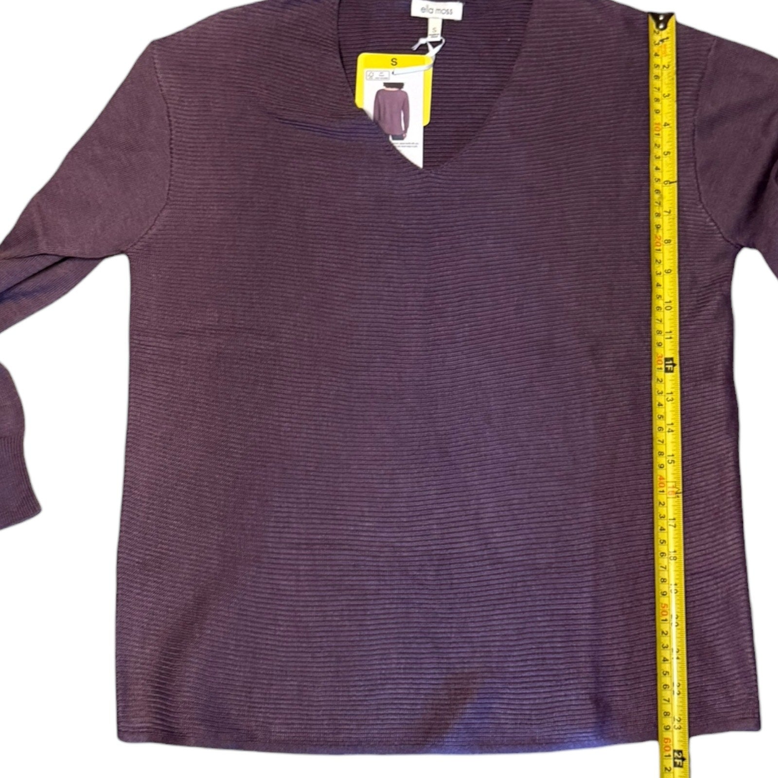 Purple sweater with a measuring tape on a white background