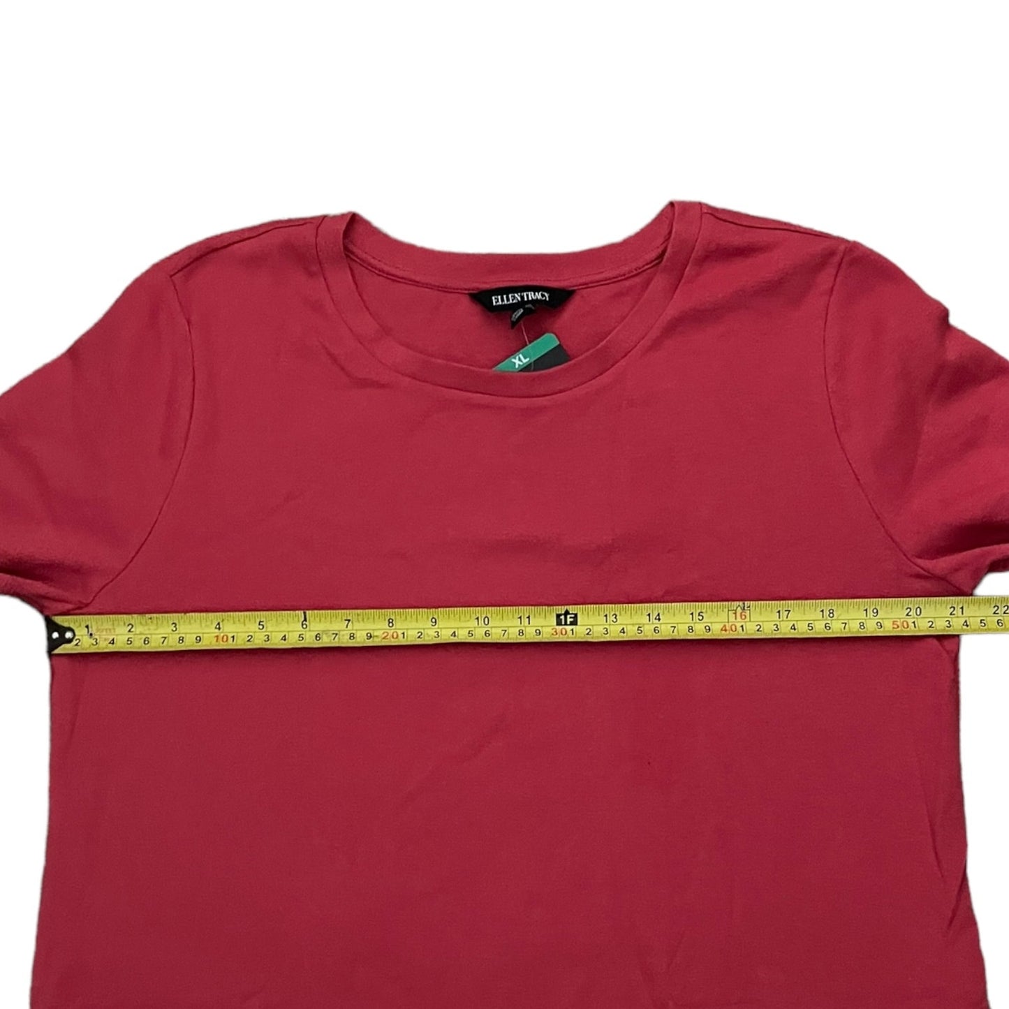Red t-shirt dress with a measuring tape across it on a white background