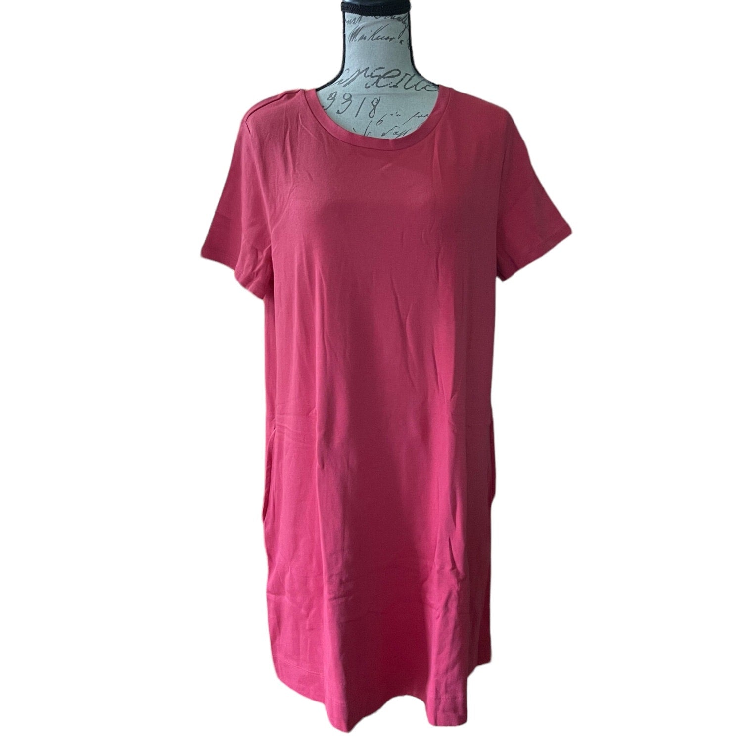 Red t-shirt dress front on a mannequin against a white background