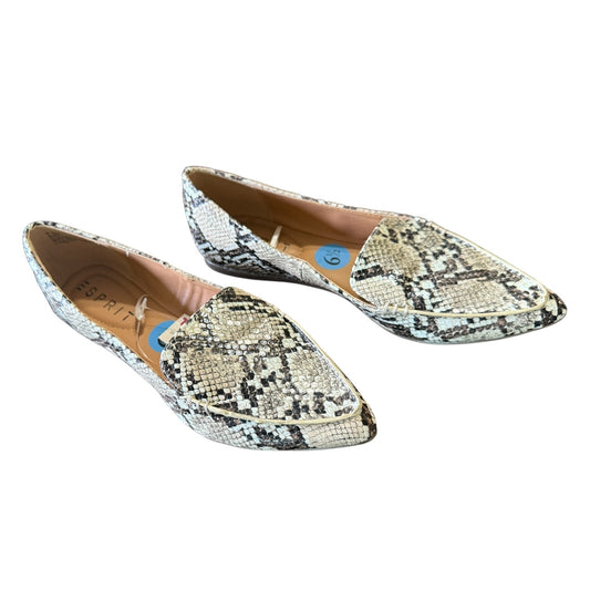 Pair of snake print loafers on a white background
