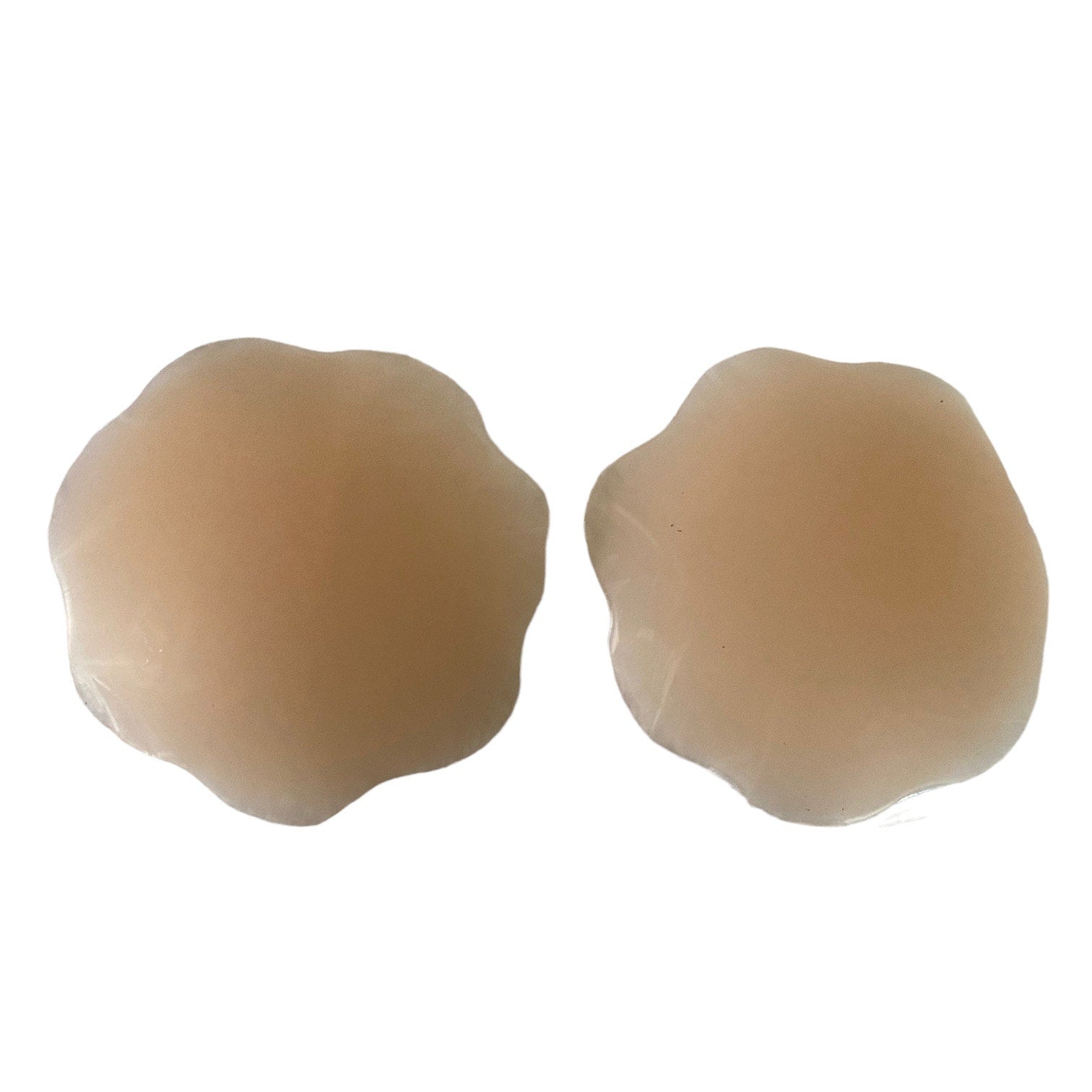 Two tan silicone adhesive nipple covers shown side-by-side on a plain white background.