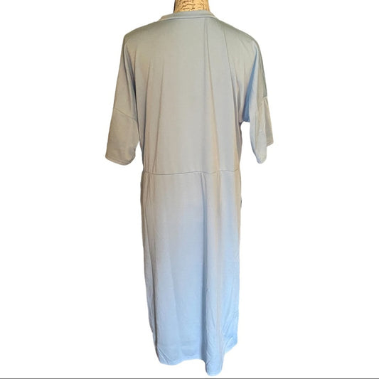 Back of Light-colored dress on a mannequin against a white background