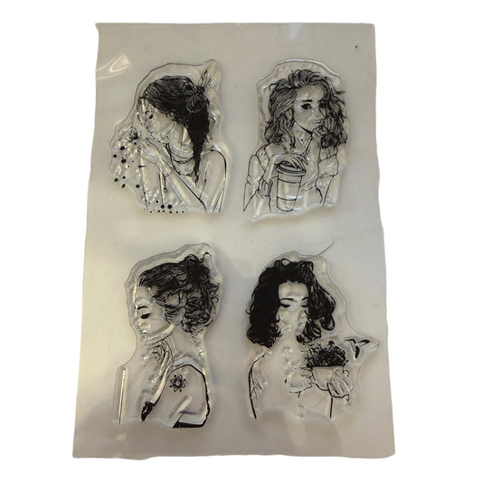 Four clear acrylic stamps featuring black ink sketches of women, displayed on a white backing sheet against a white background.