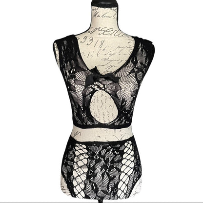 Black lace lingerie set on a mannequin against a white background