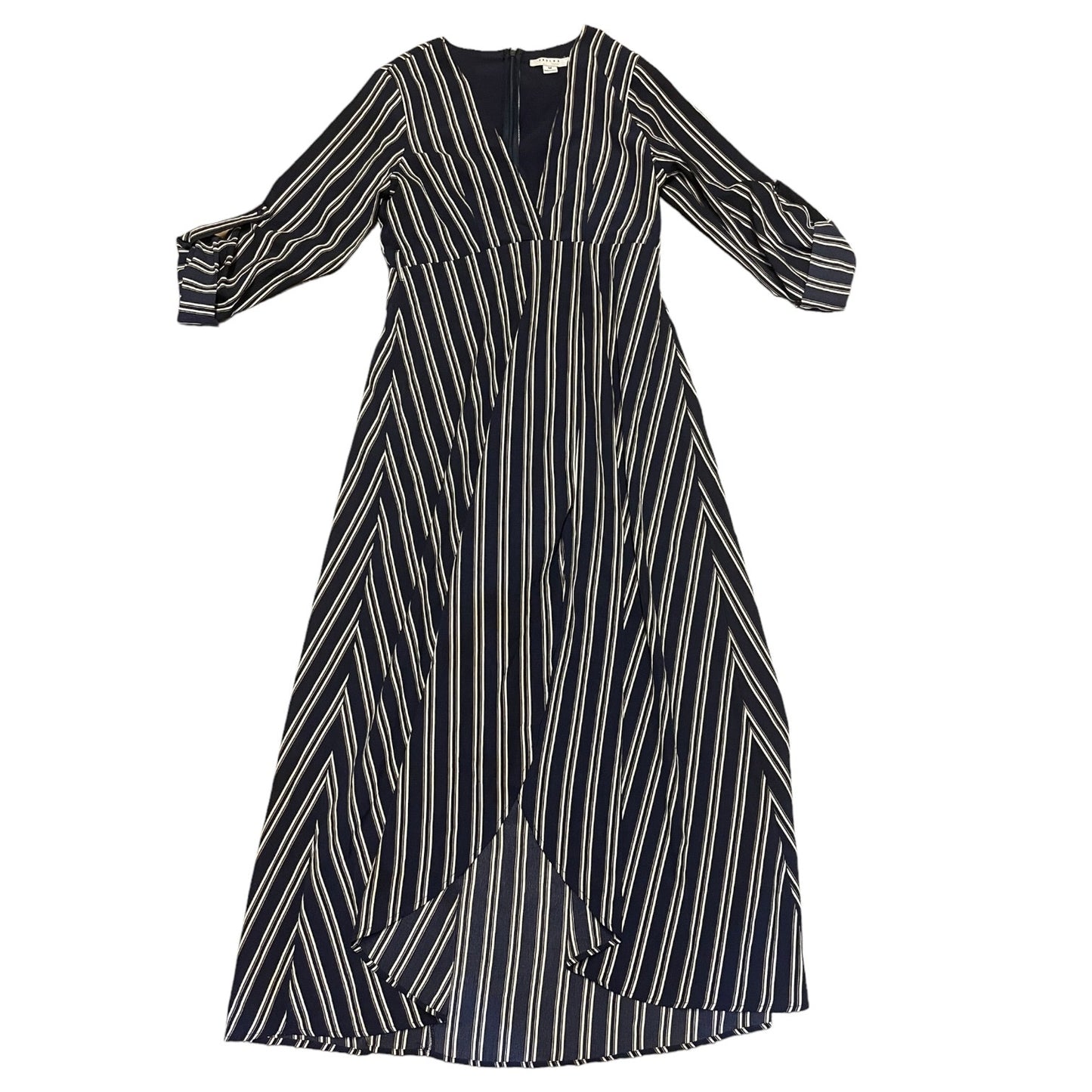 A long-sleeve midi dress with a blue base and vertical white stripes, featuring a V-neckline and a draped, asymmetrical front overlay, shown against a plain white background.
