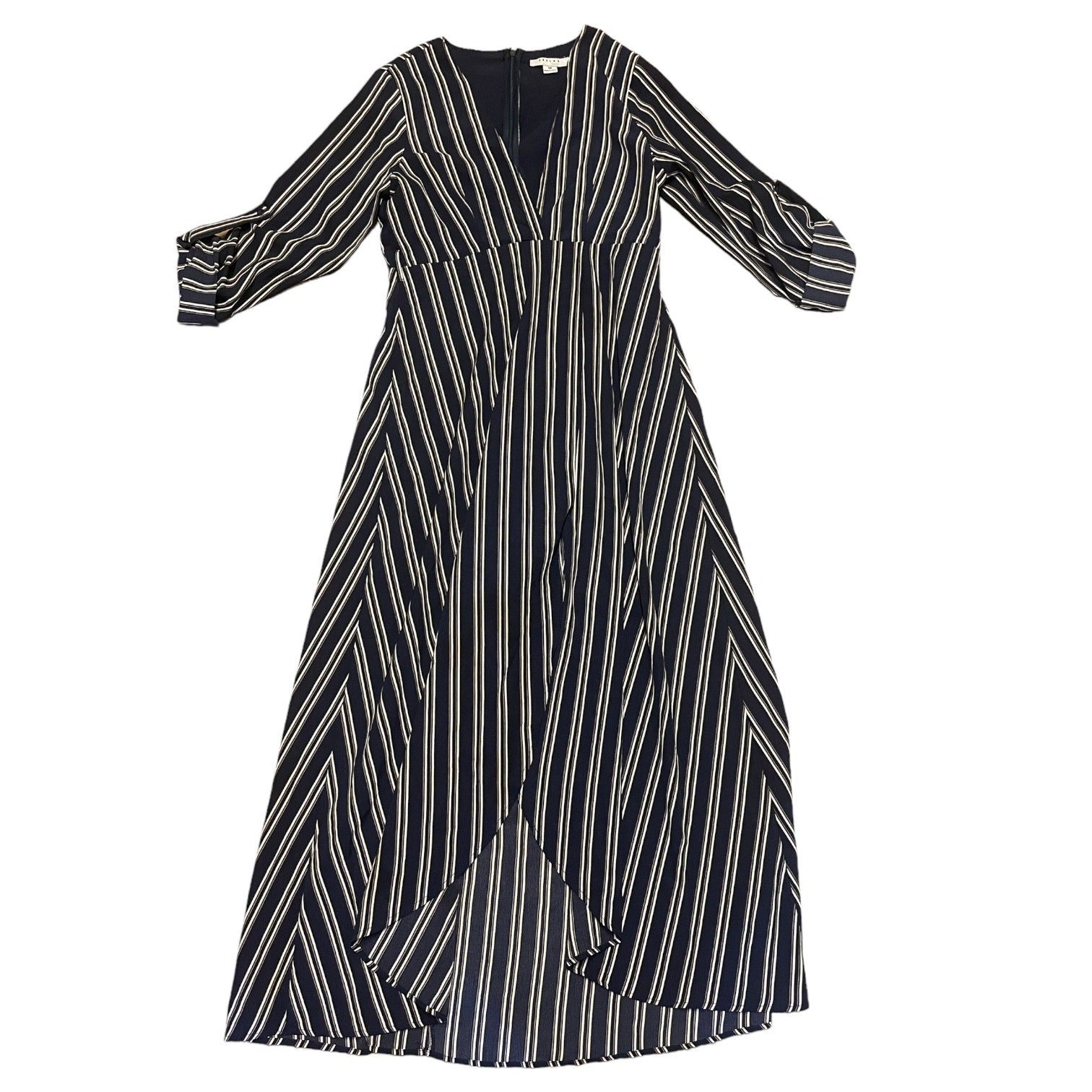 A long-sleeve midi dress with a blue base and vertical white stripes, featuring a V-neckline and a draped, asymmetrical front overlay, shown against a plain white background.