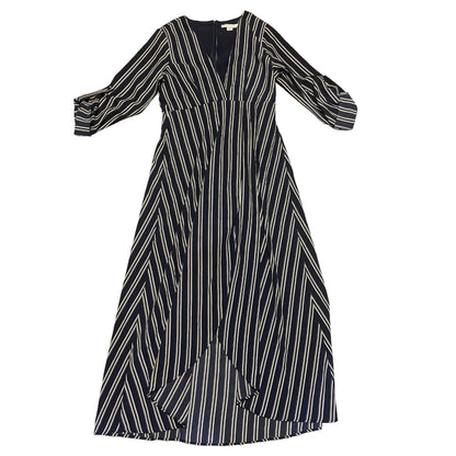 A long-sleeve midi dress with a blue base and vertical white stripes, featuring a V-neckline and a draped, asymmetrical front overlay, shown against a plain white background.