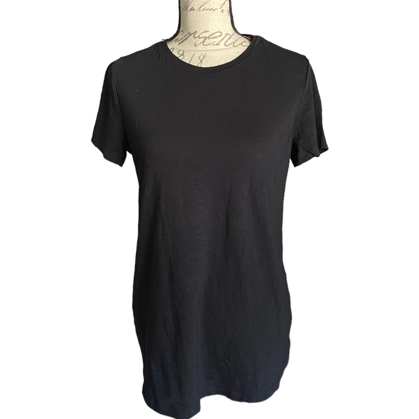 Front of Black t-shirt on a mannequin with a white background