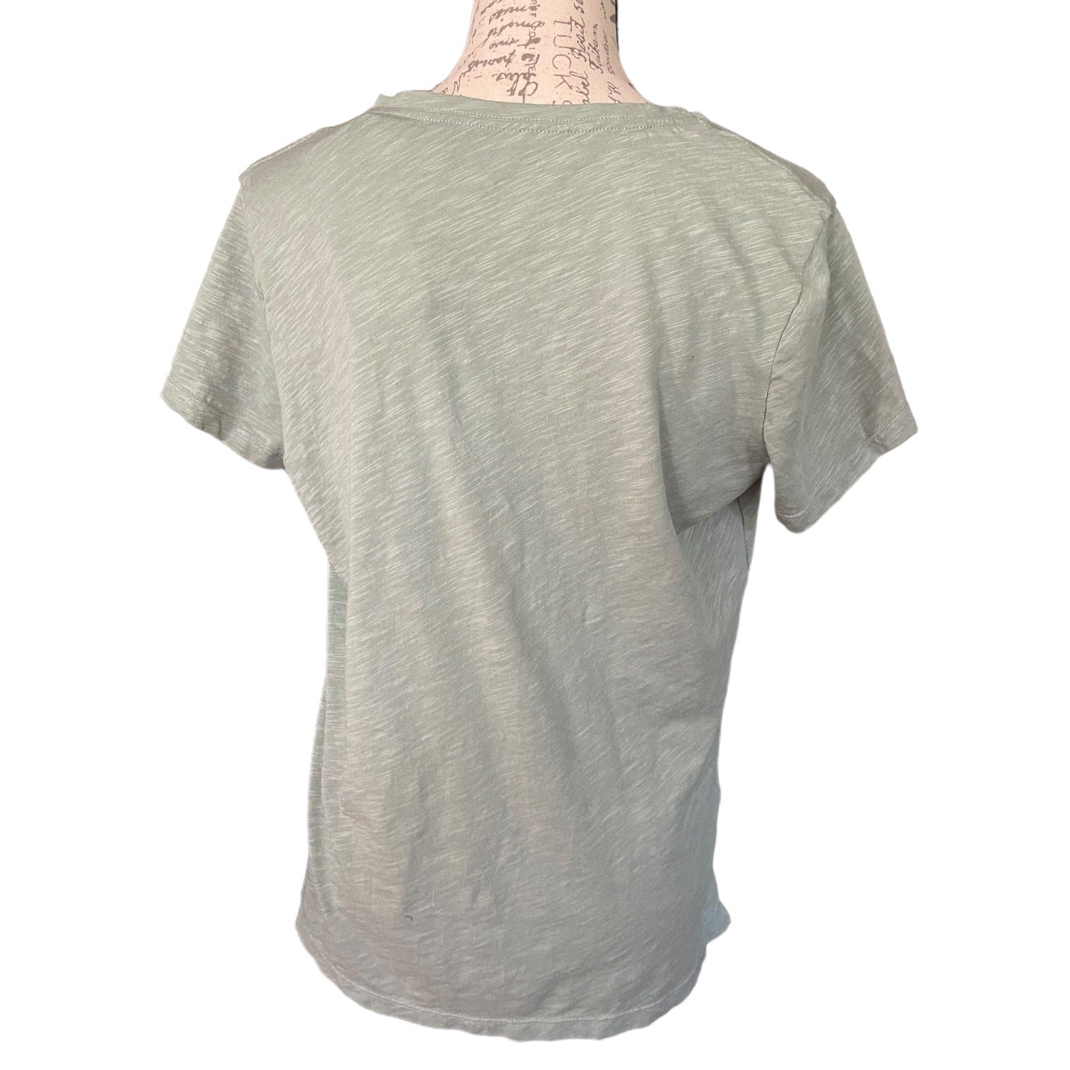 Back of Green t-shirt on a mannequin with a white background