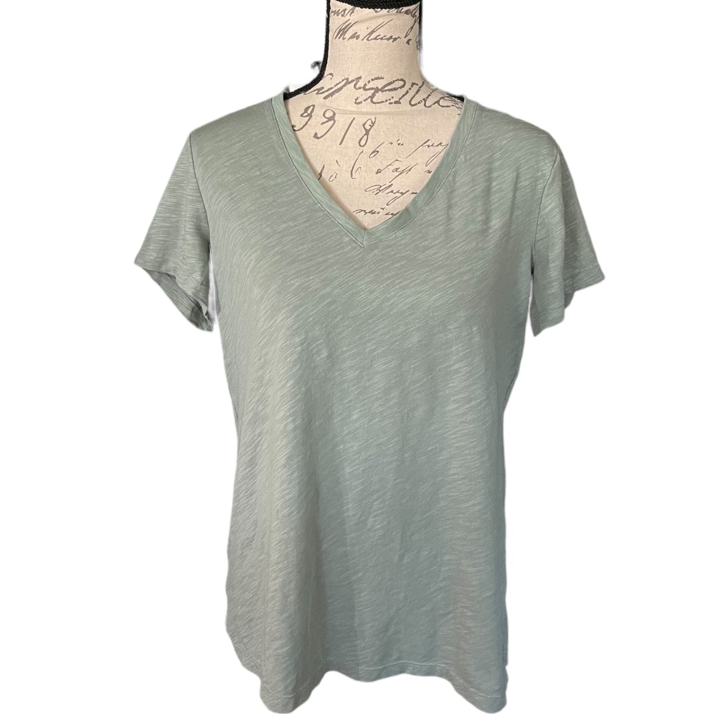 Front of Green t-shirt on a mannequin with a white background