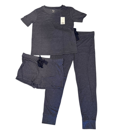 Set of navy blue pajama top and pants with shorts on a white background