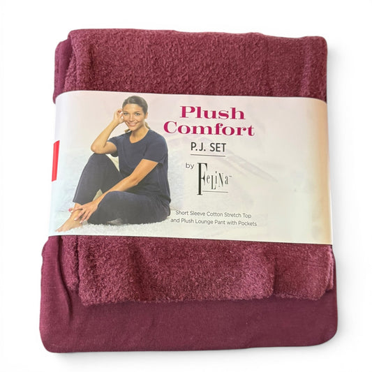 Folded maroon red pajama set with packaging featuring a model and 'Plush Comfort' text on a white background.