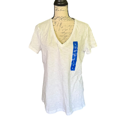 Front of Felina white cotton blend V neck shirt displayed on a mannequin with a visible blue brand tag on the side.