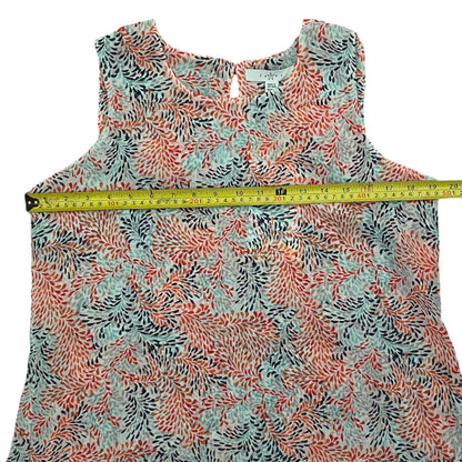 Floral patterned sleeveless top with a measuring tape on a white background