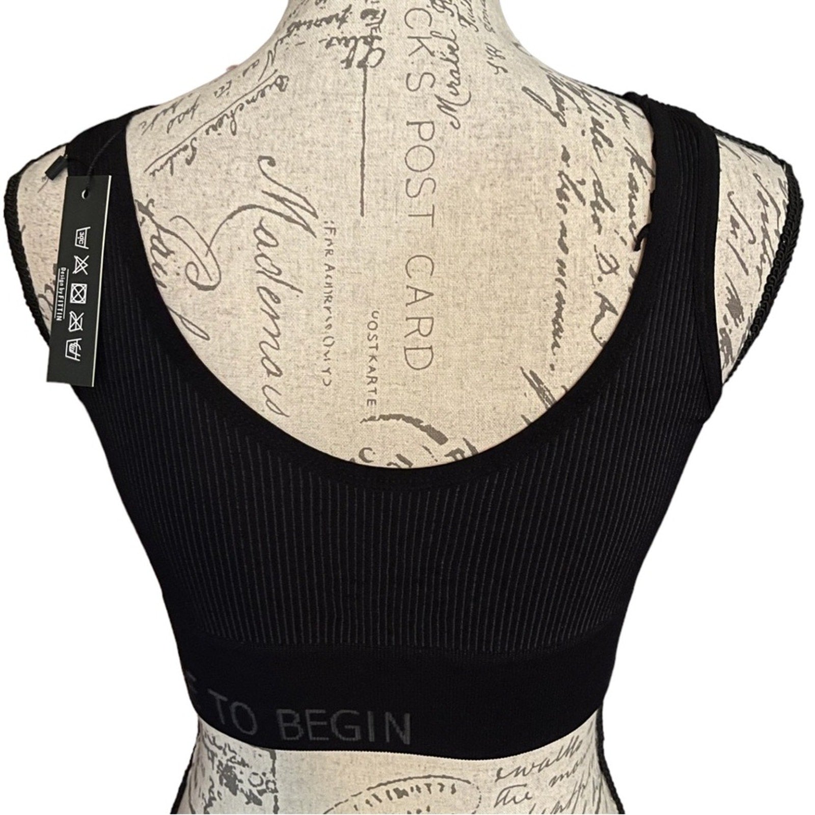 Back of black ribbed sports bra on a mannequin with a patterned back