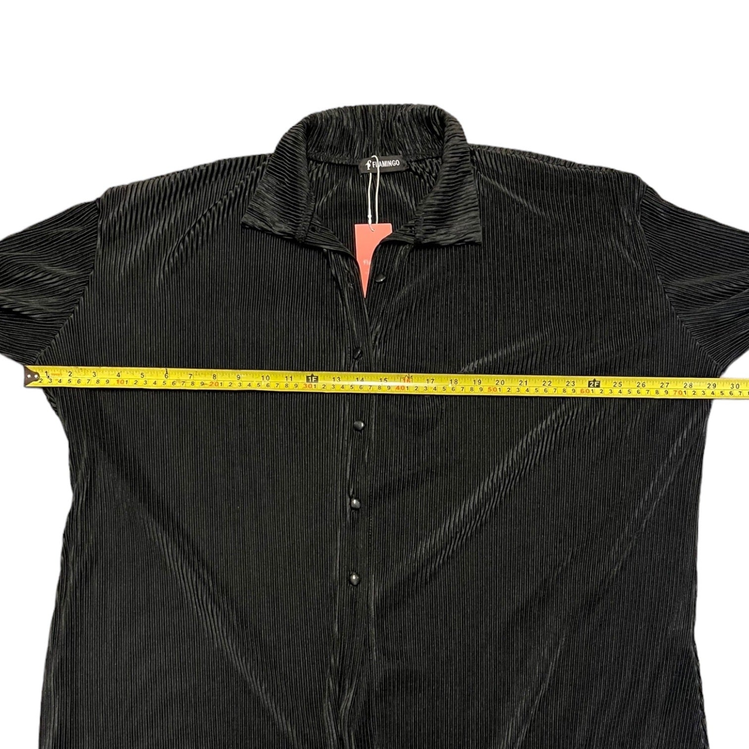 Black textured shirt with a measuring tape on a white background