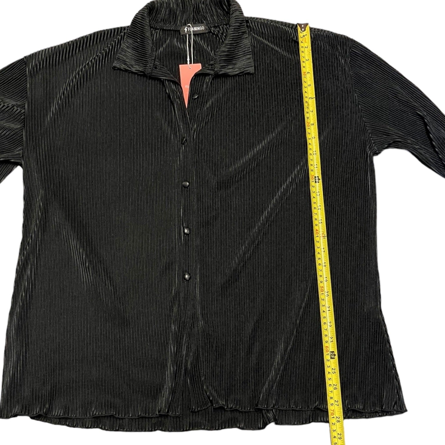 Black shirt with a measuring tape on a white background