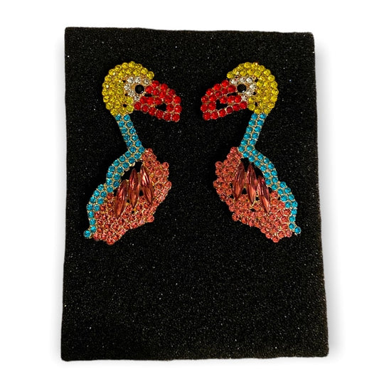 Colorful earrings of a bird on a black foam on a white background